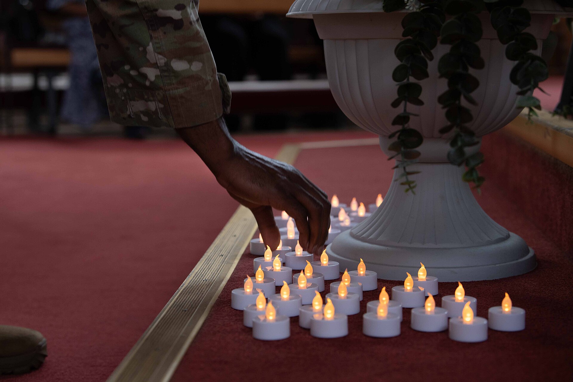 U.S. service members lay candles in honor of Senior Airman Roger Fortson during a memorial service at the Northside Chapel on Ramstein Air Base, Germany, June 6, 2024. Fortson was killed in an encounter with police May 3, 2024 at his home in Fort Walton Beach, Florida. A special missions aviator assigned to the 73rd Special Operations Squadron and 4th SOS, Fortson’s decorations included an Air Force Achievement Medal and Air Medal with a ‘C’ device, which indicates service or achievement under combat conditions. (U.S. Air Force photo by Airman Dylan Myers)