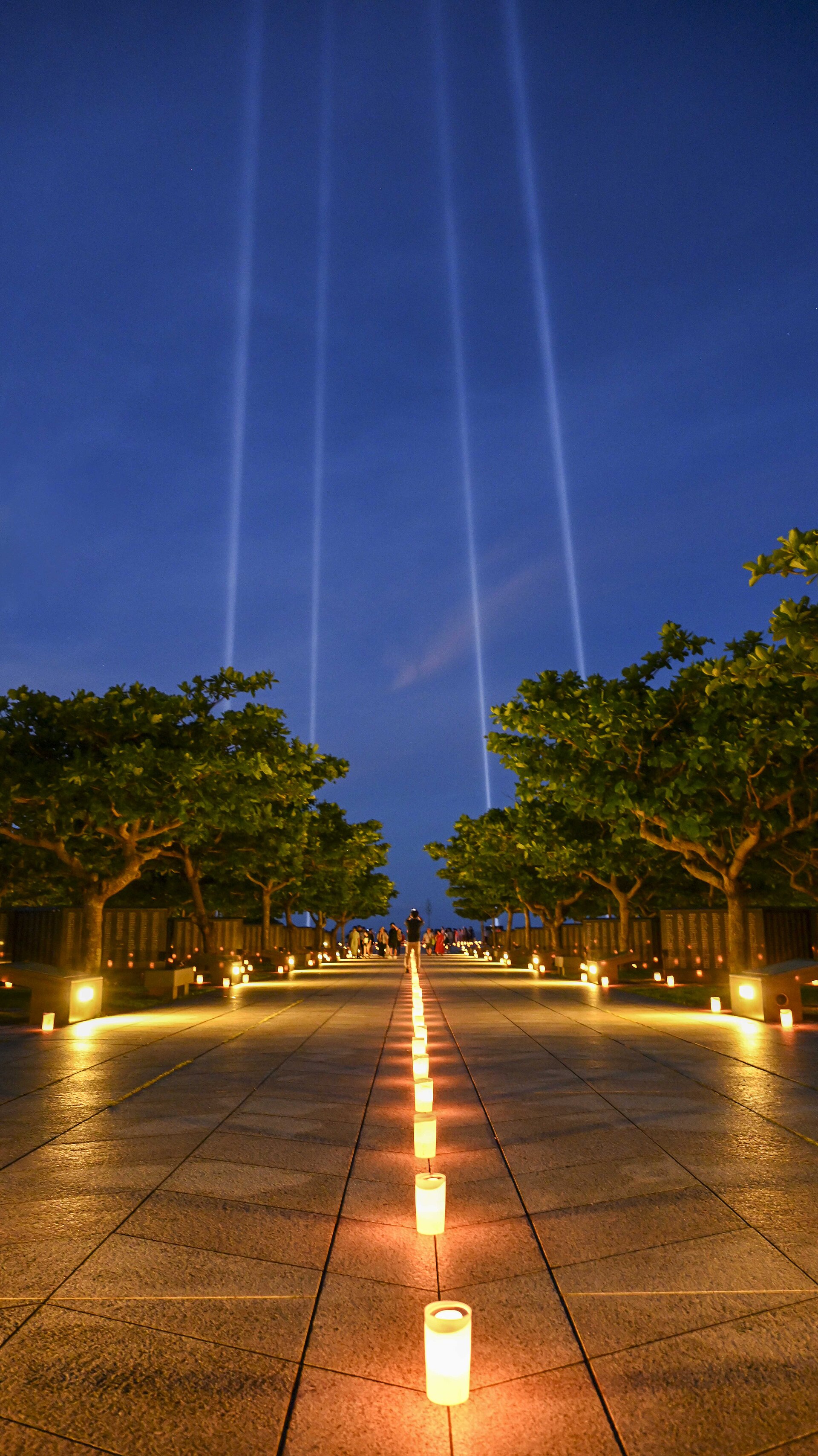 Candles lit by local volunteers and U.S. Navy Sailors stationed on Okinawa illuminate memorial walls following a volunteer candle lighting event at Peace Memorial Park in Itoman, Okinawa, Japan, June 22, 2025. Held on the eve of Okinawa Memorial Day, the event marked the 80th anniversary of the 1945 Battle of Okinawa, honoring more than 200,000 lives lost and strengthening ties between the U.S. Navy and the local community. (U.S. Navy Photo by Mass Communication Specialist 1st Class MacAdam Kane Weissman)