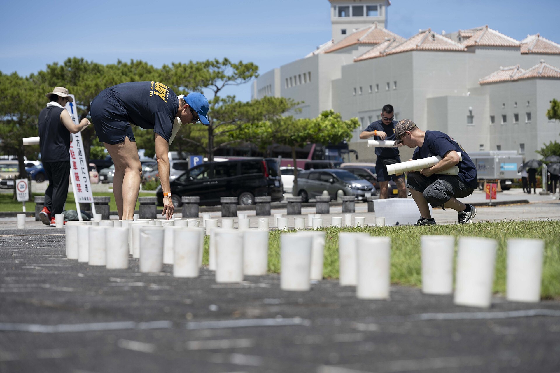 ITOMAN, Japan Hospital Corpsman 2nd Class Andrea Mayrose, left, from Salem, South Dakota, assigned to U.S. Naval Hospital Okinawa, and Sonar Technician (Submarine) 1st Class Christopher Williams, from West Palm Beach, Florida, assigned to Navy Data Center detachment Okinawa, place candle holders during a volunteer candle lighting event at Peace Memorial Park in Itoman, Okinawa, Japan, June 22, 2025. Held on the eve of Okinawa Memorial Day, the event marked the 80th anniversary of the 1945 Battle of Okinawa, honoring more than 200,000 lives lost and strengthening ties between the U.S. Navy and the local community. (U.S. Navy Photo by Mass Communication Specialist 2nd Class Zack Guth)