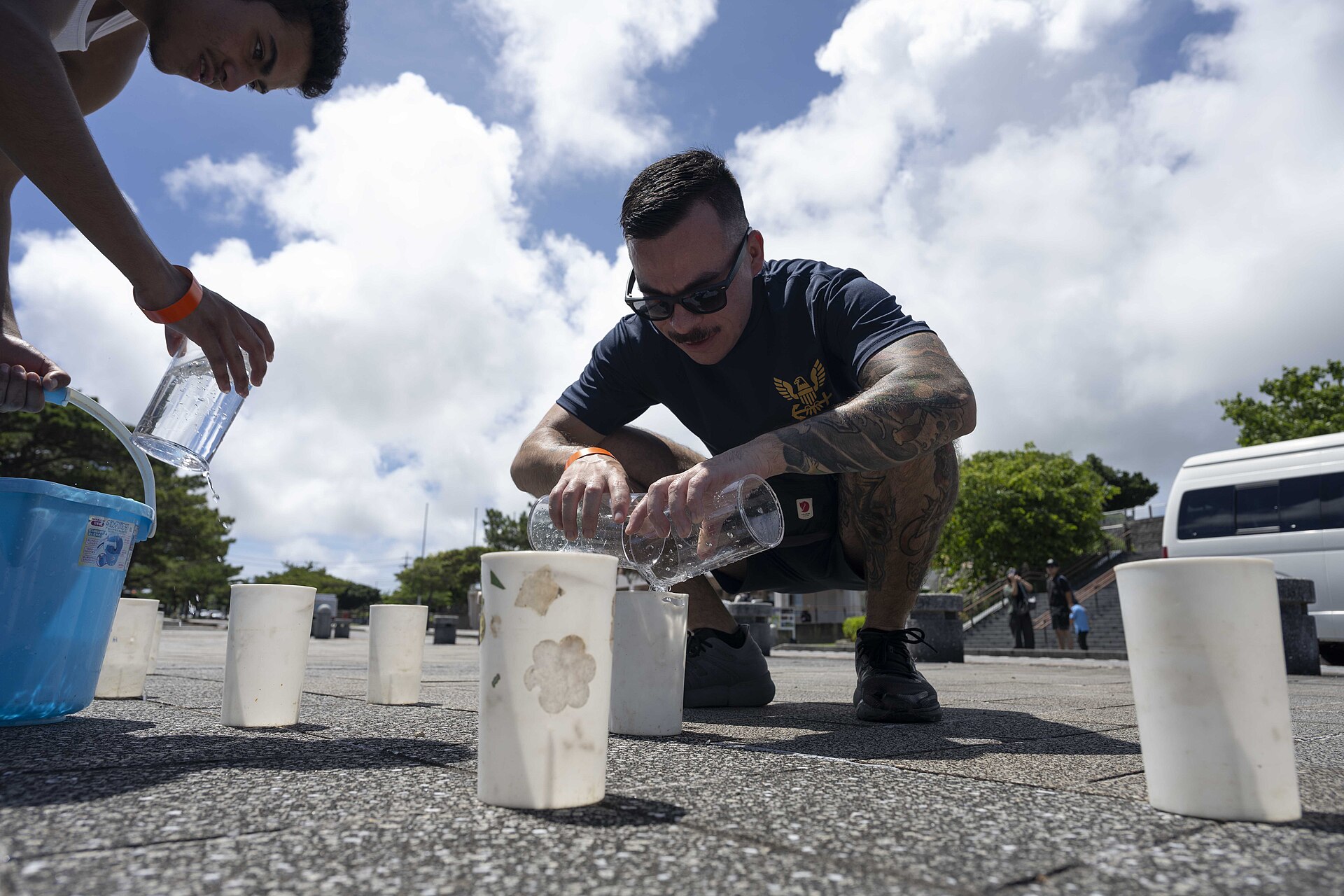 ITOMAN, Japan Hospital Corpsman 2nd Class Ruben Baltazar, from Beaumont, California, assigned to U.S. Naval Hospital Okinawa, pours water into candle holders during a volunteer candle lighting event at Peace Memorial Park in Itoman, Okinawa, Japan, June 22, 2025. Held on the eve of Okinawa Memorial Day, the event marked the 80th anniversary of the 1945 Battle of Okinawa, honoring more than 200,000 lives lost and strengthening ties between the U.S. Navy and the local community. (U.S. Navy Photo by Mass Communication Specialist 2nd Class Zack Guth)