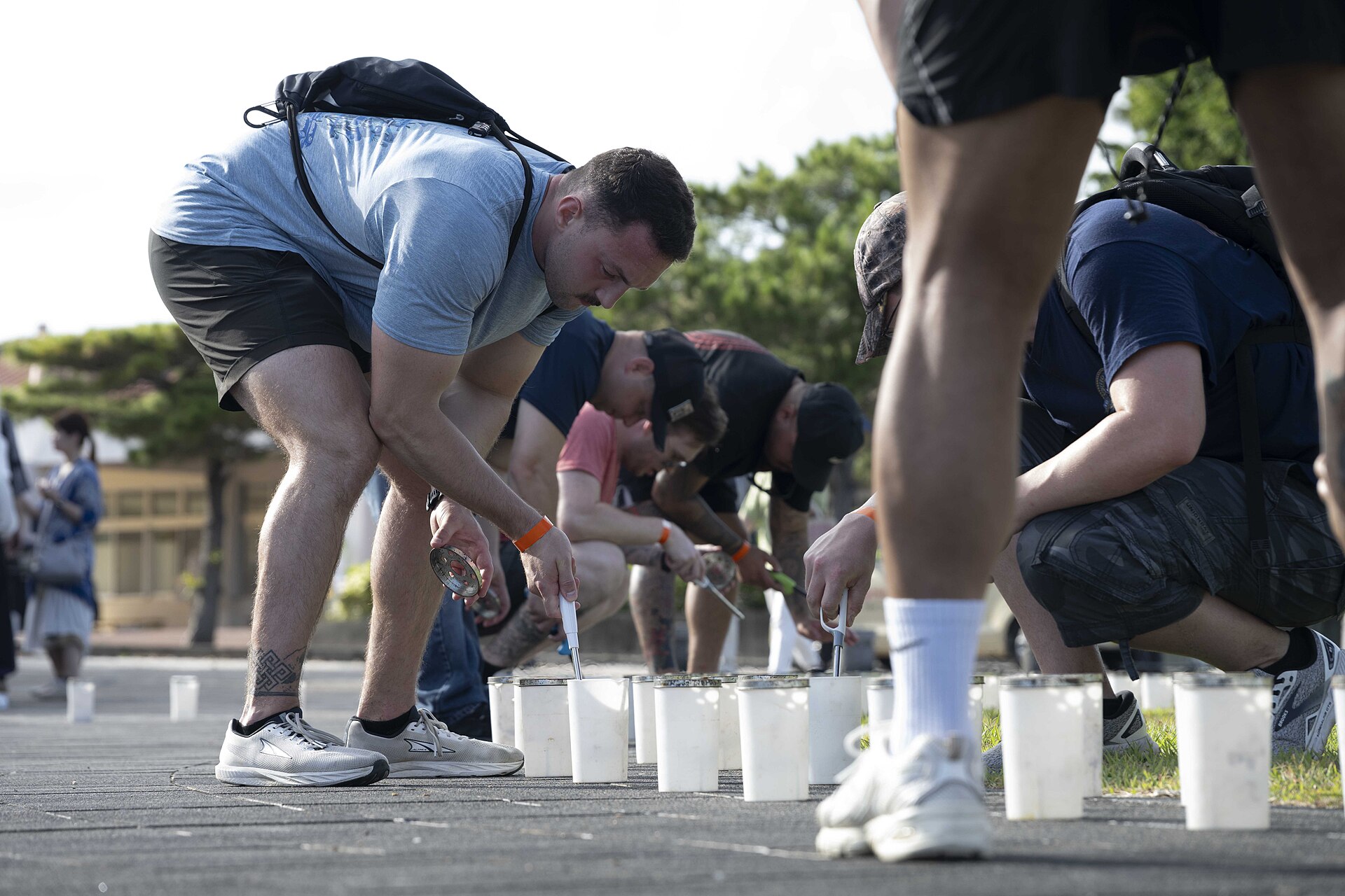 ITOMAN, Japan U.S. Navy Sailors stationd on Okinawa help light the more than 7,000 candles that illuminate the memorials walls and walk ways at Peace Memorial Park during a volunteer candle lighting event in Itoman, Okinawa, Japan, June 22, 2025. Held on the eve of Okinawa Memorial Day, the event marked the 80th anniversary of the 1945 Battle of Okinawa, honoring more than 200,000 lives lost and strengthening ties between the U.S. Navy and the local community. (U.S. Navy Photo by Mass Communication Specialist 2nd Class Zack Guth)